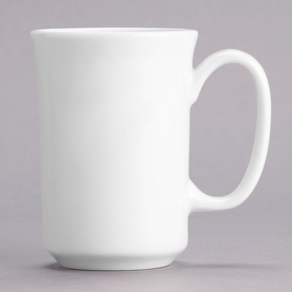 A close-up of a Tuxton AlumaTux white mug with a handle.