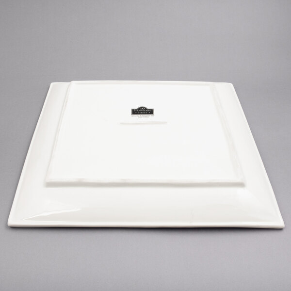 A white square platter with a black label.