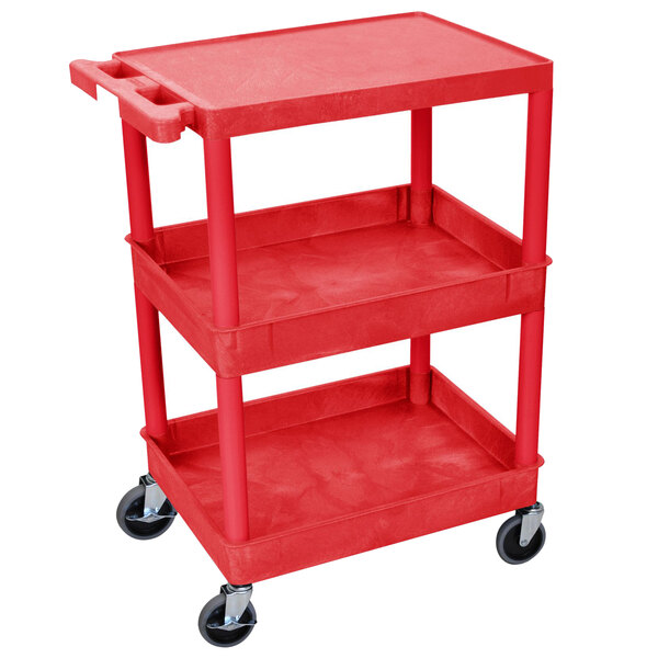 A red Luxor plastic utility cart with three shelves and wheels.