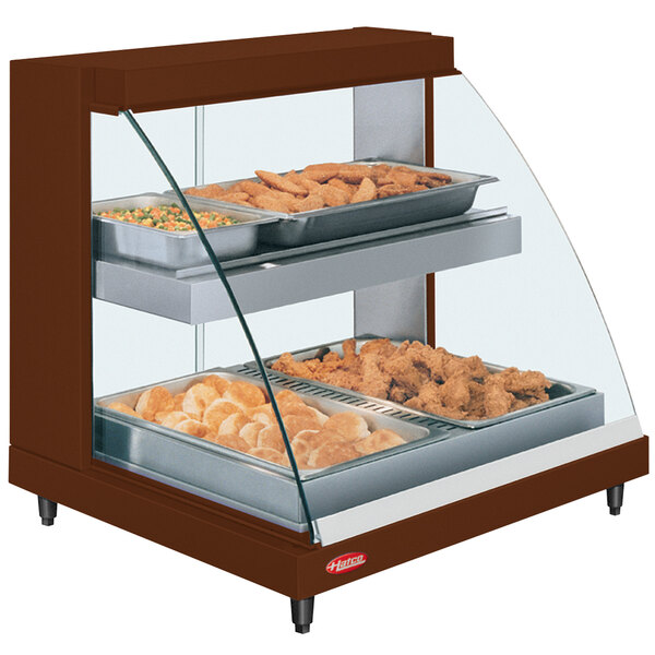 A Hatco countertop display case with food on two shelves.