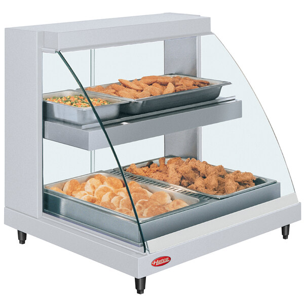 A Hatco Glo-Ray double shelf countertop food display case with food in it.