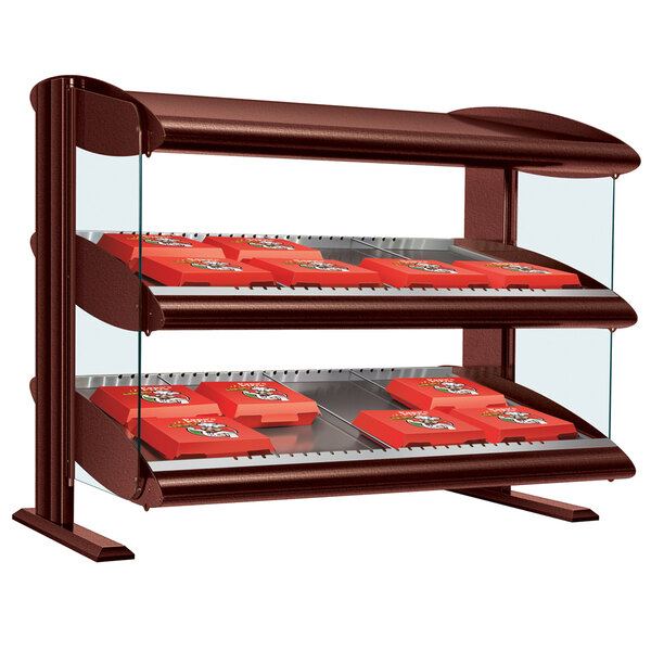 A Hatco slanted double shelf countertop merchandiser with red boxes on it.