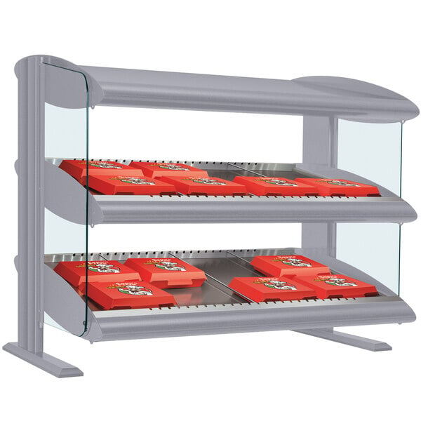 A Hatco slanted double shelf countertop display case with red boxes on it.