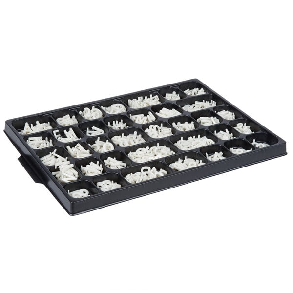 A black tray with white letters in it.