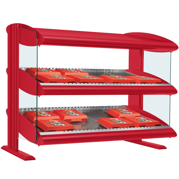 A red Hatco countertop display case with two shelves holding red food trays.