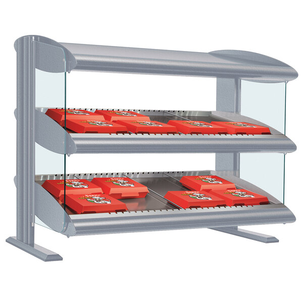 A white granite Hatco countertop display case with LED shelves holding food.