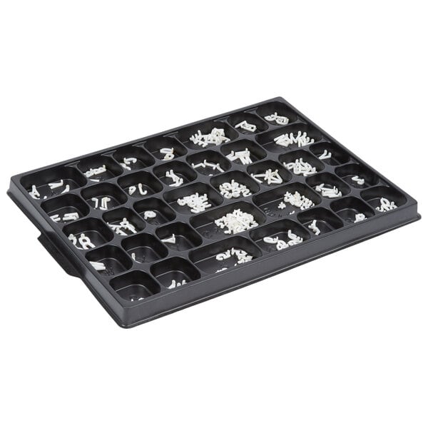 A black tray with Aarco Helvetica single tab letters and numbers in white and silver.