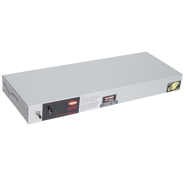 A rectangular metal white box with a red light on it.