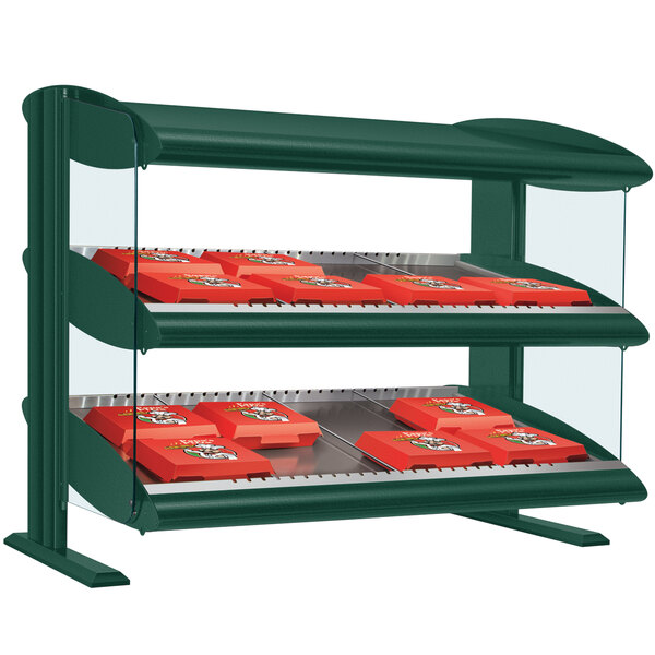 A green Hatco countertop display case with red shelves holding food.