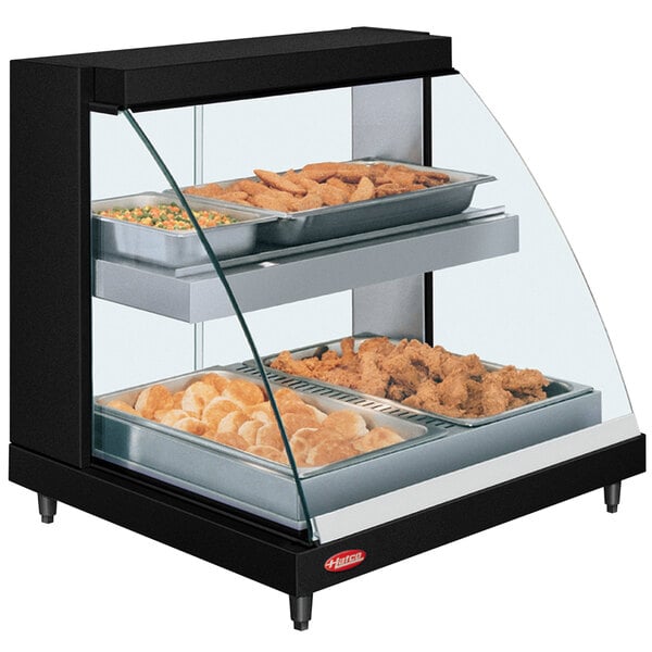 A Hatco countertop double shelf hot food display case with food in it.