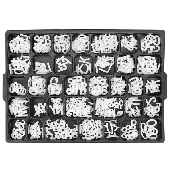 A black tray filled with white Aarco Helvetica letters and numbers.