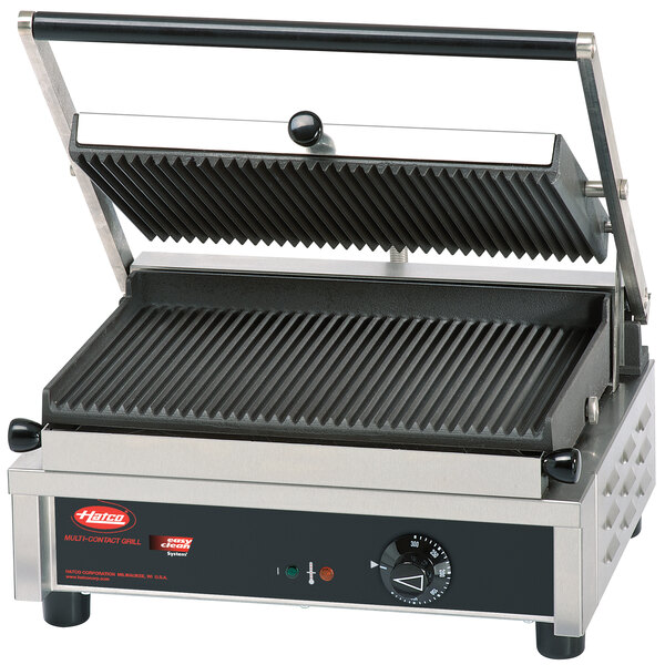 A Hatco commercial panini grill with grooved cast iron plates on a counter.