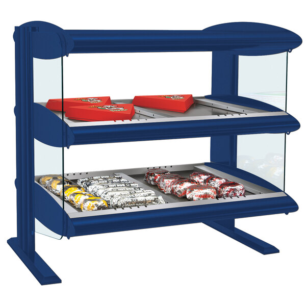 A navy blue Hatco countertop display case with two shelves of food and snacks.