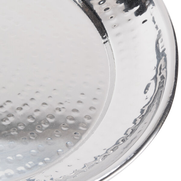 An American Metalcraft round hammered stainless steel tray with holes in it.