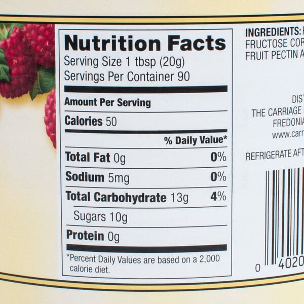 A glass jar of red raspberry preserves with a label showing raspberries.