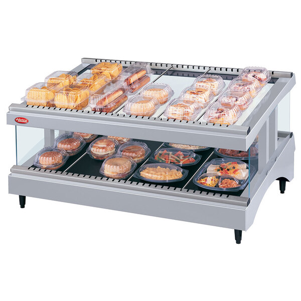 A Hatco Granite Glo-Ray heated glass shelf with food trays on it.