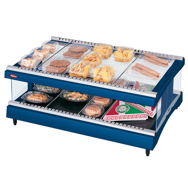 A Hatco navy blue heated countertop display case with food on a shelf.