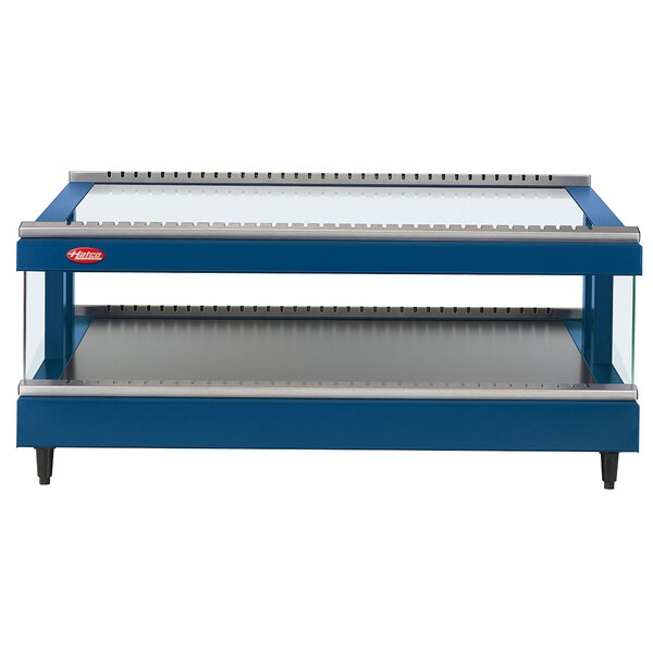 A close-up of a blue and silver shelf in a Hatco countertop display warmer.