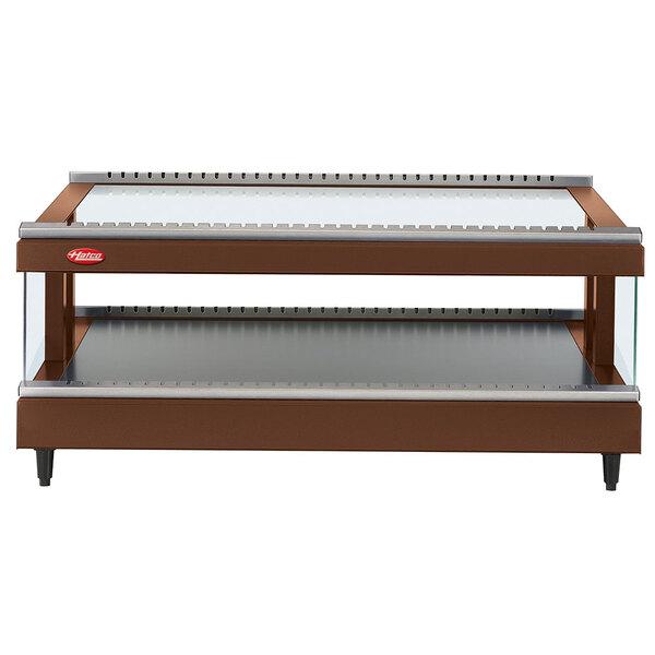 A brown and silver Hatco countertop heated display shelf in a bakery.
