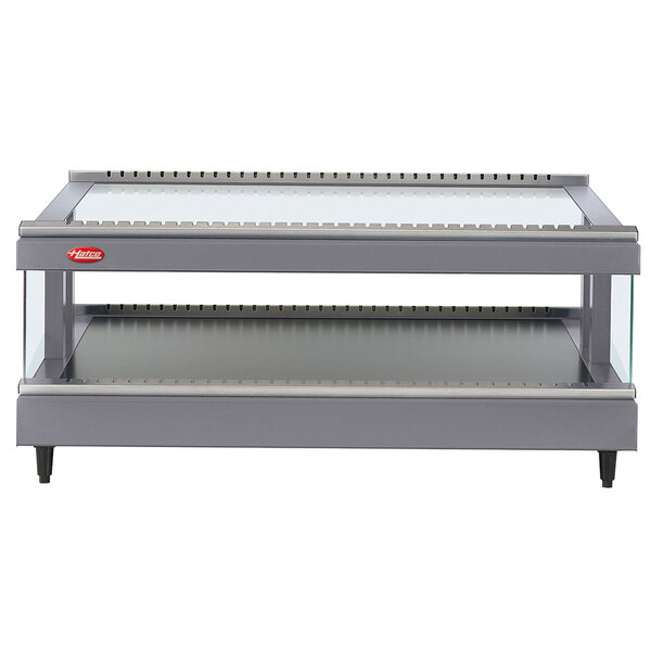 A Hatco gray granite heated glass merchandising warmer on a metal shelf.