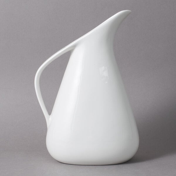 A white pitcher with a handle.