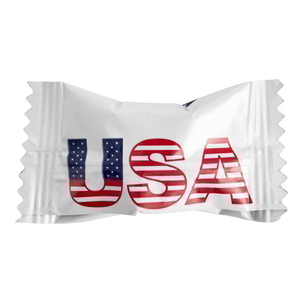 A white individually wrapped buttermint with 'USA' printed in American flag colors on the packaging.