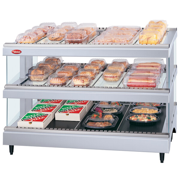 A Hatco Granite Glo-Ray countertop heated glass display case with food on shelves.