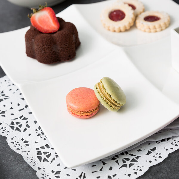 A white porcelain tapas tray with three different desserts on it.