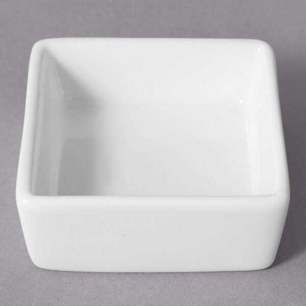 A white square 10 Strawberry Street sauce dish.