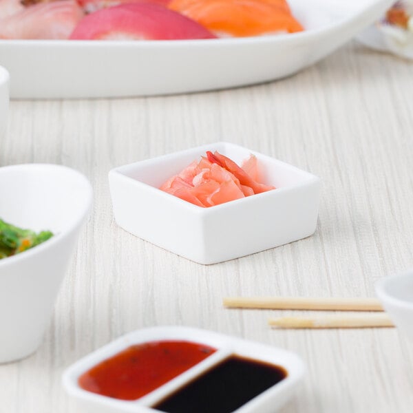 A table set with white square 10 Strawberry Street sauce dishes filled with different types of food.