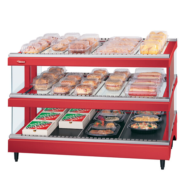 A red Hatco display case with food on it.