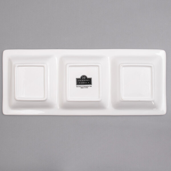A white rectangular porcelain tray with three square compartments.