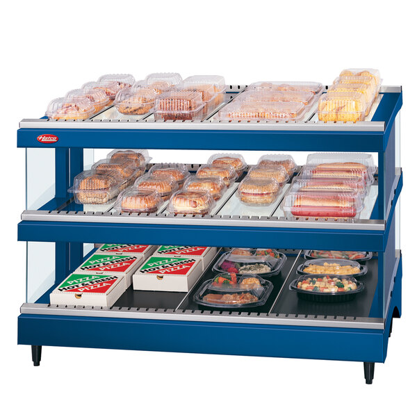 A Hatco navy blue heated glass food display case with shelves of food inside.