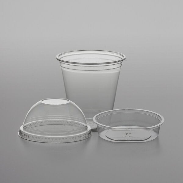 A clear plastic cup with a Fabri-Kal insert and a dome lid.