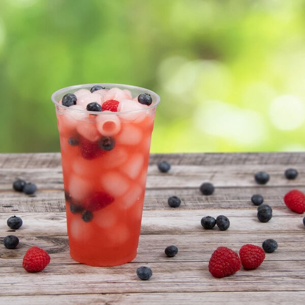 A Solo Ultra Clear PET plastic cup of red drink with ice and berries.