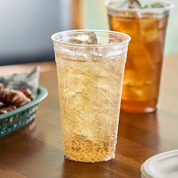 A table with Solo Ultra Clear plastic cups filled with iced tea.