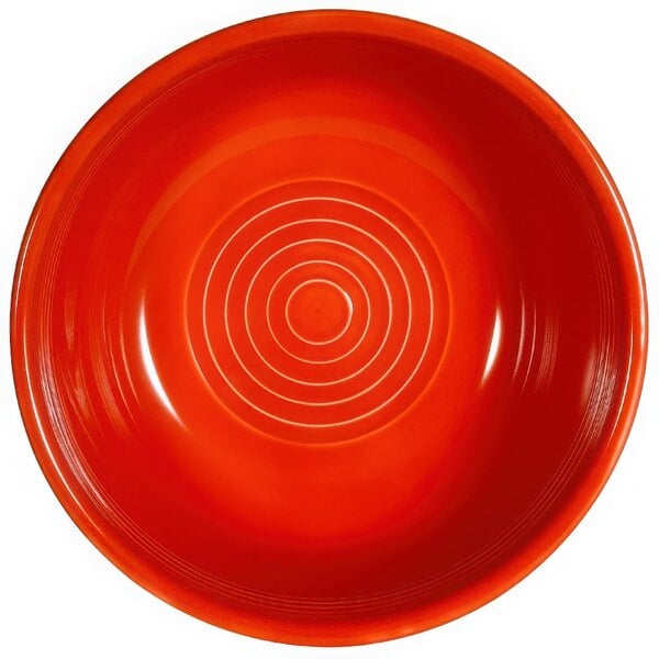 A red bowl with a spiral pattern on it.