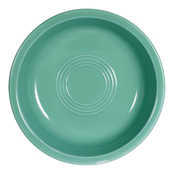 A close-up of a green CAC Tango round nappie bowl with a circular design.