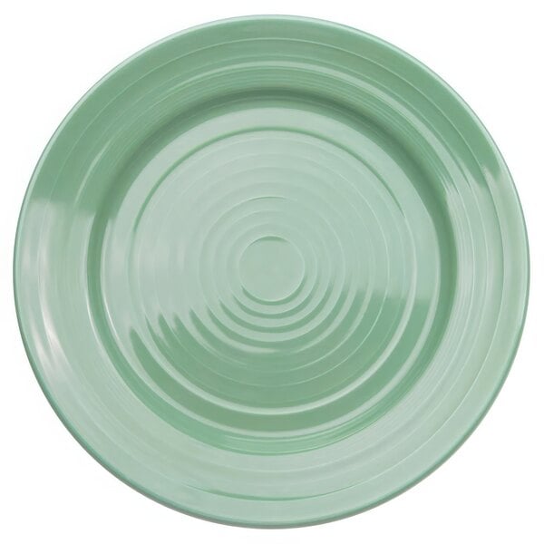 A green porcelain round plate with a spiral design.