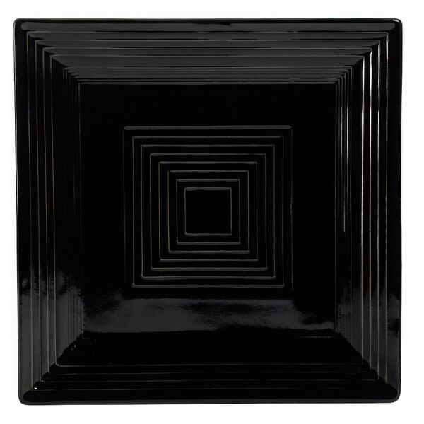 A black square porcelain plate with a geometric design on the border.