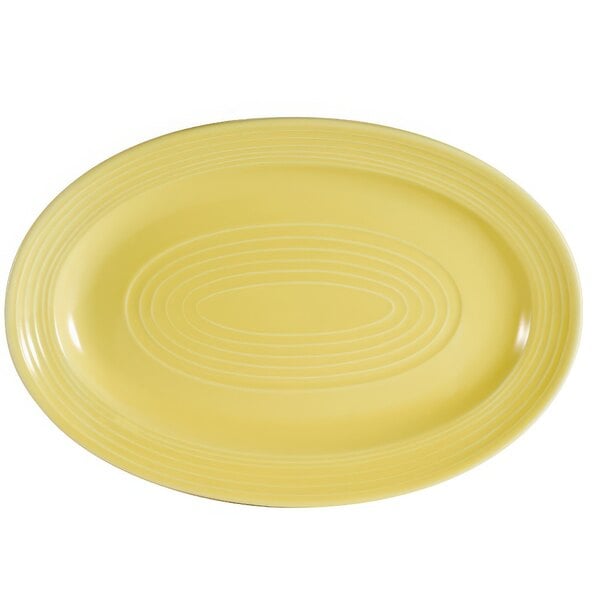 A yellow oval platter with a sunflower pattern.