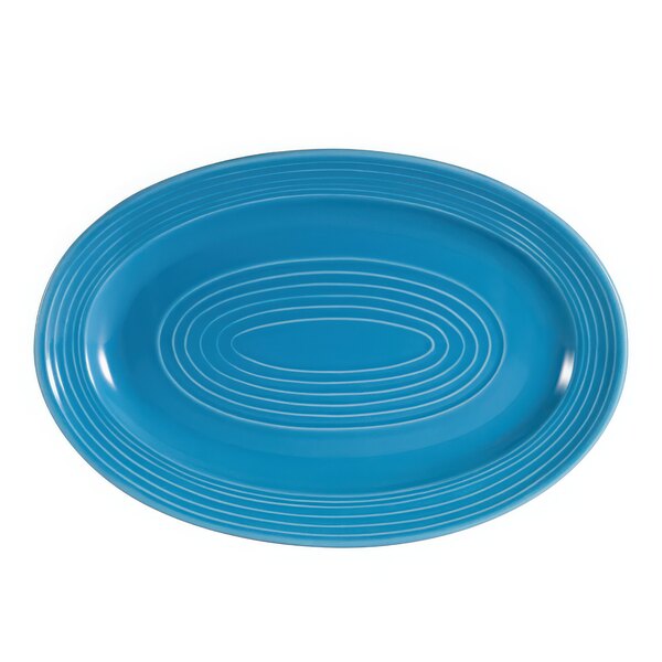 A blue oval platter with white lines in a spiral design.