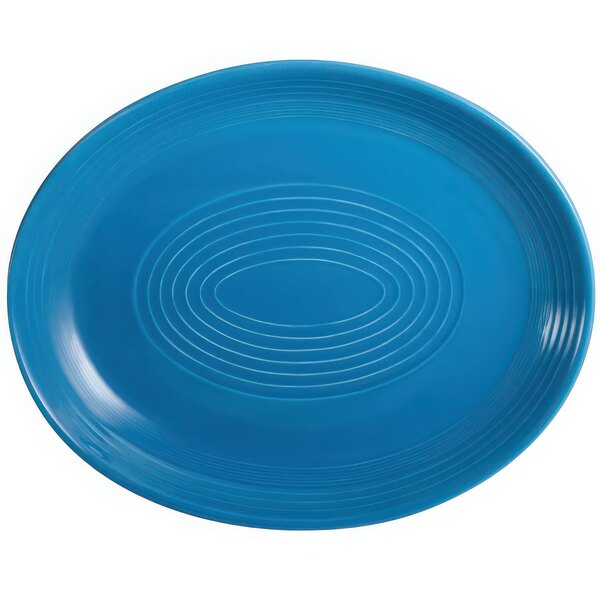 A blue oval platter with a white spiral pattern.