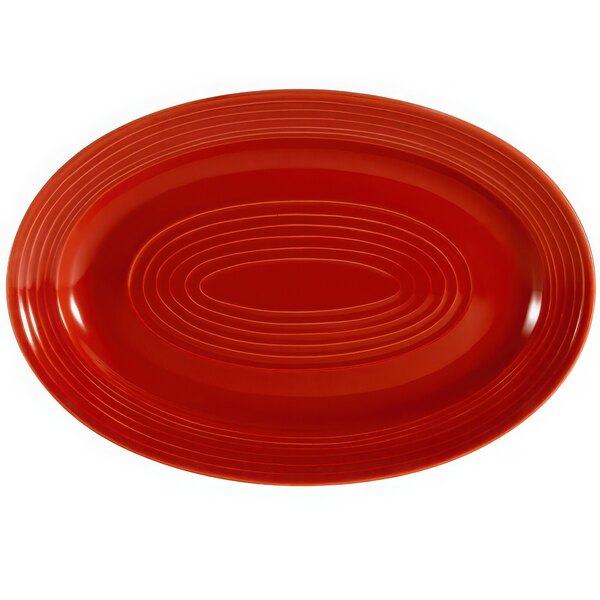 A red oval platter with an oval pattern.