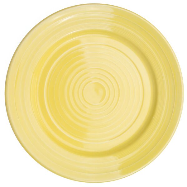 A yellow round plate with a sunflower design in the center.