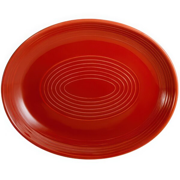 A red oval platter with a white spiral pattern.