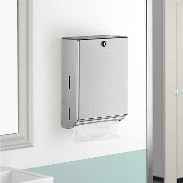 A silver Bobrick surface-mounted paper towel dispenser on a wall.