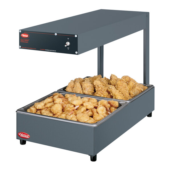 A Hatco Glo-Ray food warmer with two trays of food.
