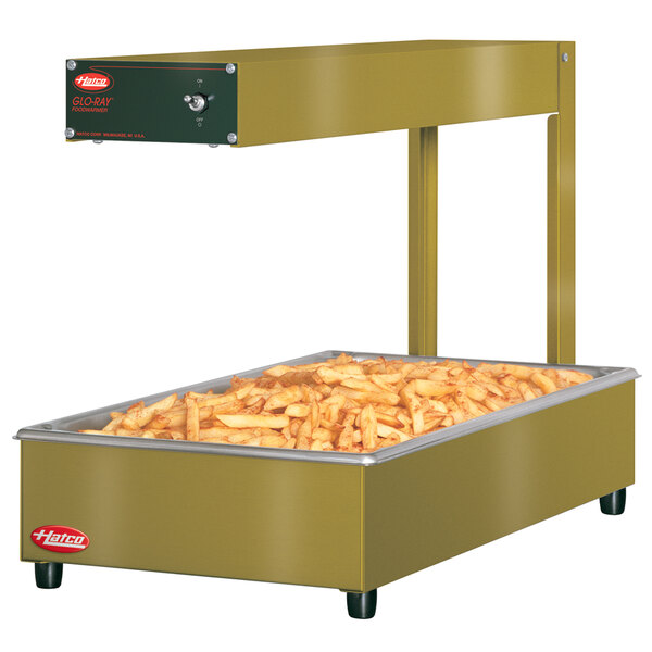 A large rectangular Hatco food warmer with french fries inside.