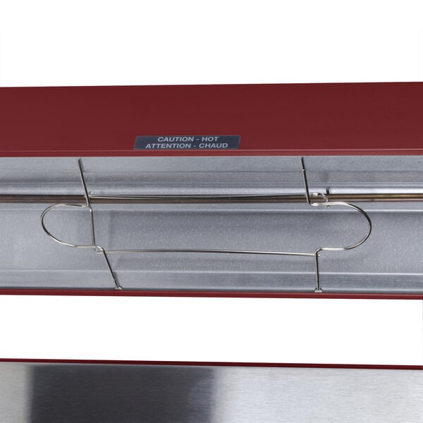 A Hatco radiant red portable French fry warmer with metal rods and a red handle.
